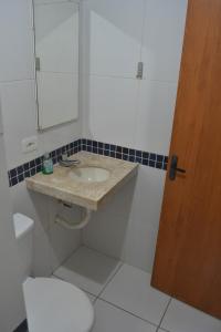 a bathroom with a sink and a toilet at Chacara Maluco Beleza 2 in Gravatá