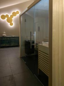 a bathroom with a sink and a glass wall at The Kepos Hotel Erlangen in Erlangen