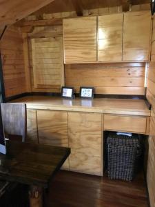 Una cabaña con un escritorio con dos relojes. en Acogedora cabaña de madera en la naturaleza para desconectarse, en Sogamoso