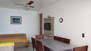 a living room with a couch and a table at Apto Pé na Areia Santos in Santos