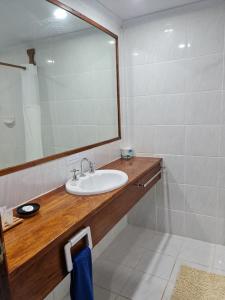 a bathroom with a sink and a large mirror at Tawali Leisure & Dive Resort in Alotau +53 photos