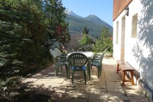 a table and chairs on a patio with a view at Le Clos du Vas - Puy Saint André in Puy-Saint-André