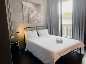 a bedroom with a bed with two candles on it at The LOCAL Ari in Bangkok +65 photos