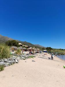 a beach with a group of houses and people on it at Cabaña Balcón Serrano in Cortaderas