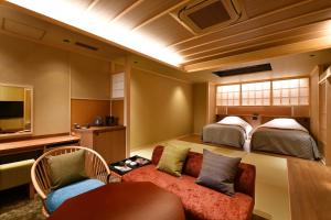 a hotel room with two beds and a couch at Kyo Yunohana Resort Suisen in Kameoka