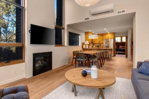 a living room with a table and a fireplace at Red Pine Wonder in Park City