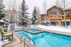 a house with a swimming pool in the snow at Evergreens 12 in Steamboat Springs