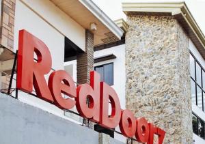 a sign for a restaurant in front of a building at RedDoorz @ Poblacion Sur Sigma in Sigma