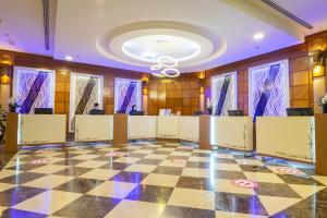 a lobby with a checkered floor and a ceiling at Seri Pacific Hotel Kuala Lumpur in Kuala Lumpur