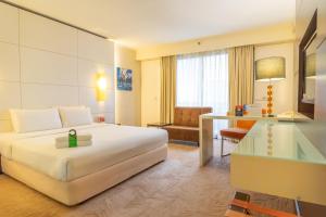 a hotel room with a bed and a desk at Seri Pacific Hotel Kuala Lumpur in Kuala Lumpur +58 photos