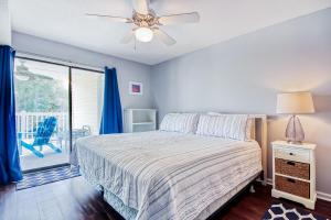 a bedroom with a bed and a ceiling fan at Dogwood 201 in Myrtle Beach