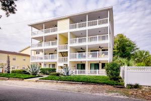 a white apartment building with balconies on a street at Dogwood 201 in Myrtle Beach