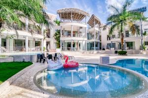 a pool in front of a building with a resort at Hermosa Waves A2 in Playa Hermosa