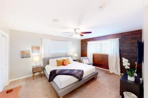 a bedroom with a white bed and a ceiling fan at Dallas Charmer in Dallas