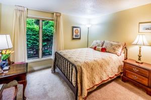 a bedroom with a bed and a desk and a window at The Guest House at Big Bear Estates in Waynesville