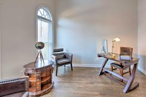 a living room with a desk and a table with a laptop at Updated Mableton Home about 14 Miles to Downtown ATL! in Mableton +28 photos