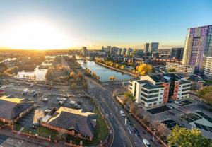 an aerial view of a city with a river and buildings at Luxury Apartment Manchester With Balcony Views in Manchester