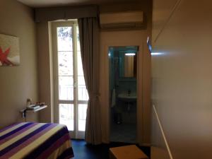 a bedroom with a bed and a window at Hotel l'Approdo in Porto Azzurro