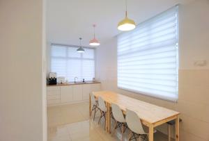 a dining room with a wooden table and chairs at Desaru Kids Water Slide Private Pool & BBQ Homestay Bandar Penawar in Bandar Penawar