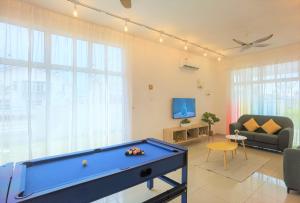 a living room with a pool table in it at Desaru Kids Water Slide Private Pool & BBQ Homestay Bandar Penawar in Bandar Penawar