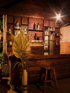 a bar with a vase with a plant in front of it at Da'Kayu Bali Homestay in Munduk