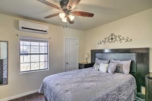 a bedroom with a bed with a ceiling fan at Quaint Roswell Retreat about 1 Mi to Main Street! in Roswell