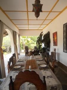 a long table in a room with a long table at Sunset Villa Eco Friendly House in Kilifi