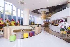 a flower shop with colorful chairs and flowers at Mermaid Seaside Hotel in Vung Tau