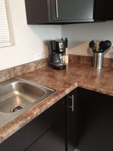 a kitchen counter with a sink and a coffee maker at Otay 2 bedroom condo in Tijuana