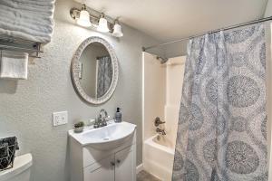 a bathroom with a sink and a shower curtain at 11 Mi to Lake Ouachita Family Cabin with Yard in Royal +19 photos