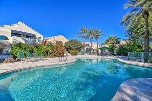 a large swimming pool in a yard with palm trees at 6 Mi to Downtown Condo with Patio in Tempe! in Tempe