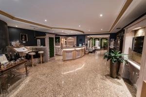 a large room with blue walls and a lobby at Hotel Blauer Engel in Aue