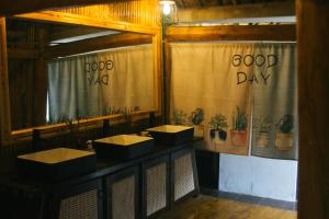 a bathroom with three sinks with plants on the curtain at Homestay số 91-Suối Hồ Sa Pa in Sapa