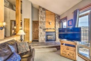 a living room with a tv and a fireplace at Ski-InandSki-Out Granby Ranch Retreat with Mtn View! in Granby