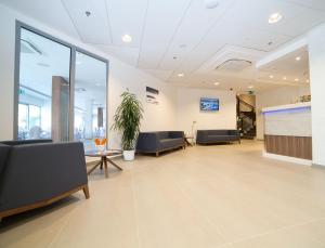 an office lobby with chairs and a large screen at Aparthotel Miramare in Makarska