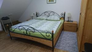 a bedroom with a bed and a night stand with a lamp at Ferienwohnung Spatzennest in Fladungen