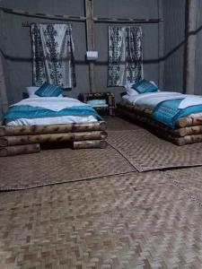 A bed or beds in a room at ENCHANTING MAJULI