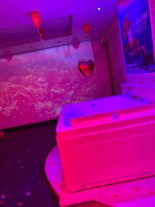 a pink room with a aquarium and a heart balloon at Il Gladiatore in Rome