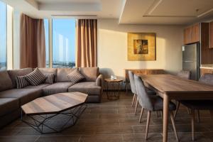 a living room with a couch and a table at Mirada Purple Zahra - Serviced Apartments in Jeddah