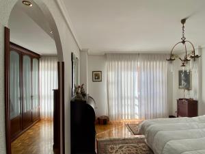 een slaapkamer met een bed en een groot raam bij Espacioso chalet en urbanización con piscina cerca del centro de Haro in Haro