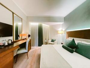 a hotel room with a bed and a large mirror at Ilica Hotel Spa & Wellness Resort in Çeşme