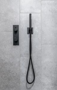 a shower with a hose attached to a wall at Hoeve De Blauwe Zaal in Bruges +91 photos