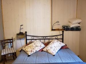 a bed with two pillows on it in a room at Auberge La Bergerie in Sainte-Marie-de-Campan