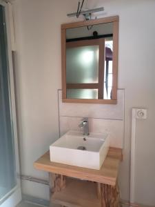 a bathroom with a white sink and a mirror at Auberge La Bergerie in Sainte-Marie-de-Campan