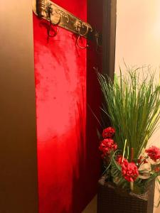 a red door with flowers and plants in front of it at B&B Le Terrazze in Bologna