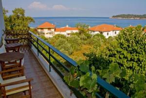 a balcony with benches and a view of the ocean at Blue Bay Beach Hotel in Koinyra