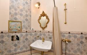 a bathroom with a sink and a mirror at Royal Hotel in Varna City +66 photos