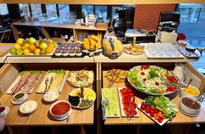 a buffet with many different types of food on a table at Citadel Express in Tbilisi City