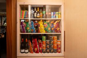 a cabinet filled with lots of drinks and snacks at Hotel Breitner in Rotterdam