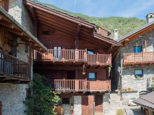 a building with wooden balconies on the side of it at Mont Blanc Apartments in Morgex